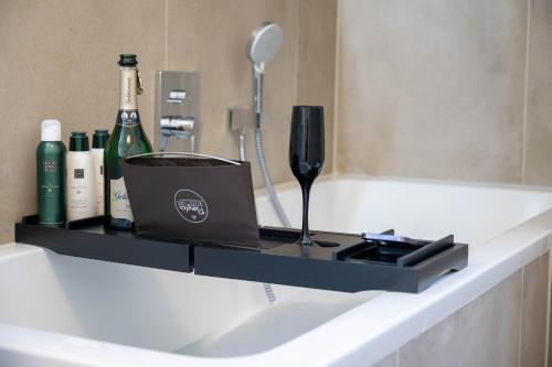a shelf with bottles and wine bottles on a bathroom counter at Lit Living - Luxury - Box Spring - Parking - 4 Bed Rooms - 13 persons - Duplex apartment in Hemsbach