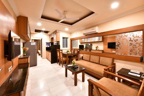 a living room with a couch and a table at Click White House Residency, Vadodara in Vadodara