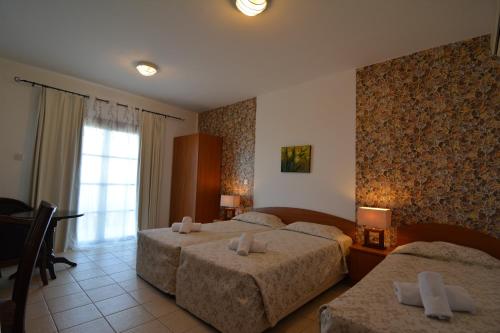 Postel nebo postele na pokoji v ubytování Palates Hotel