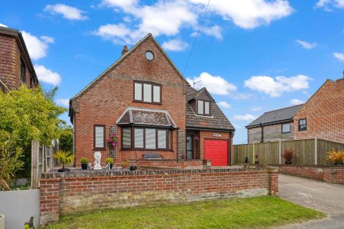 a brick house with a red door at House - Sleeps 6 & Free parking in Great Yarmouth