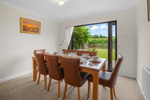 a dining room with a table and chairs and a window at House - Sleeps 6 & Free parking in Great Yarmouth