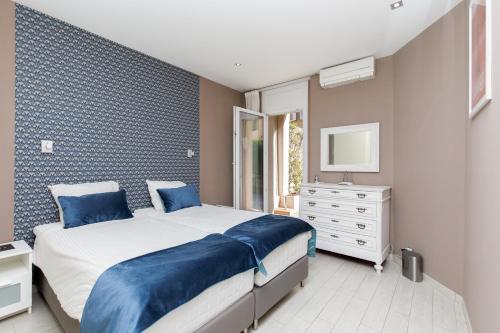 a bedroom with a bed and a dresser and a mirror at beautiful 3 room-flat near palais in Cannes