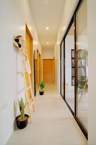 a staircase leading to the hallway of a house at Bali-inspired Villa with Dipping Pool by Pallet Homes in Iloilo City