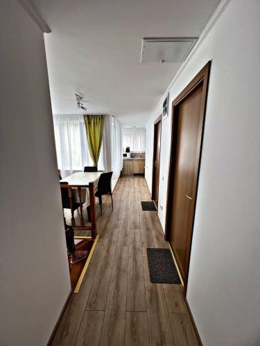 a hallway with a table and a dining room at Casa Milla in Sovata