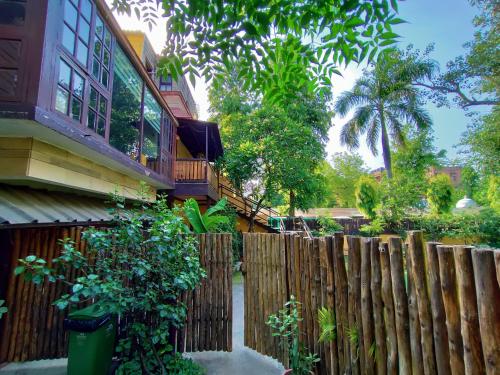 a wooden fence in front of a house at Cp Villa - Rooms with Patio in New Delhi