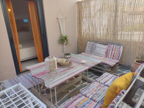 a patio with a table and chairs in a room at Votsalon Beach House in Katastárion