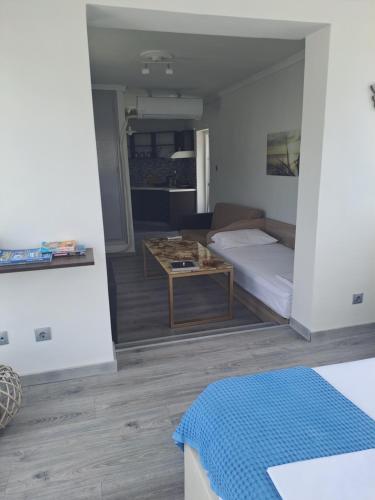 a living room with a bed and a table at Diamond View in Kavala