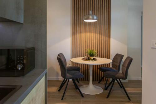 a dining room with a table and four chairs at Flat4us#cozy#freeparking#5people in Zagreb