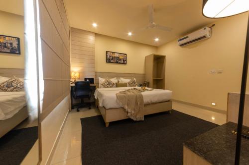 a hotel room with a bed and a desk in it at Sagar Hotel JUST 5 MIN FROM GOLDEN TEMPLE in Amritsar