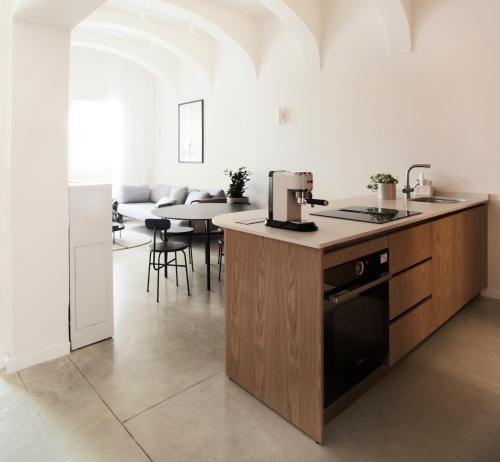 a kitchen with a counter and a table with chairs at Trabuxu Boutique Living in Valletta
