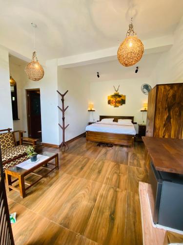 a bedroom with a bed and a living room at The kingdom of ella in Ella
