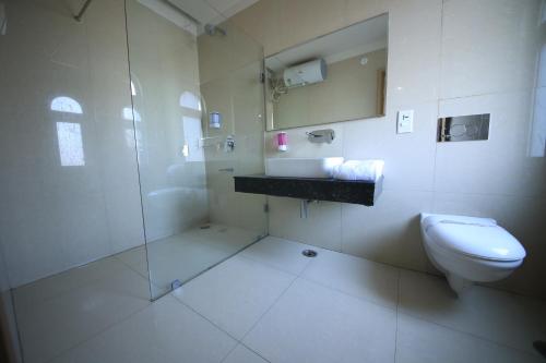 a bathroom with a shower and a toilet and a sink at Sagar Hotel JUST 5 MIN FROM GOLDEN TEMPLE in Amritsar