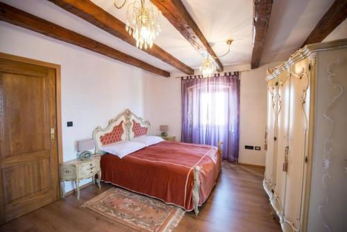 a bedroom with a bed and a chandelier at House Polic in Hreljin