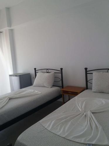 a room with two beds and a table at Paradise View in Himare