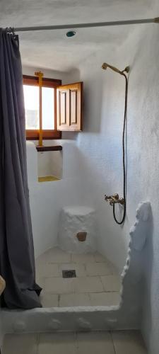 a bathroom with a shower and a shower curtain at Cuevas Los Coloraos - La Residencia in Villanueva de las Torres