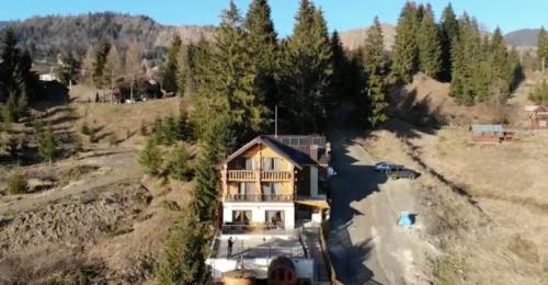 an aerial view of a house on a hill at Chalet du Lac in Colibiţa