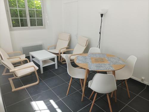 uma sala de espera com uma mesa e cadeiras em O'Couvent - Appartement 62 m2 - 2 chambres - A513 em Salins-les-Bains