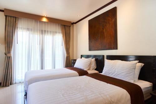 a hotel room with two beds and a window at Ananda Private Pool Villa, Ao Nang in Krabi town