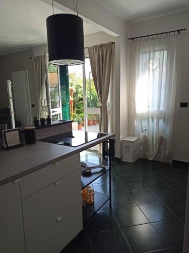 a kitchen with a counter top and a mirror at Il Glicine cozy appartamnent, near Sestri Levante between Cinque terre e Portofino in Casarza Ligure