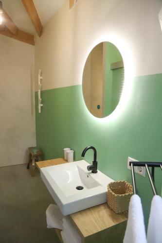 a bathroom with a white sink and a mirror at Silo 161 in Ruinerwold