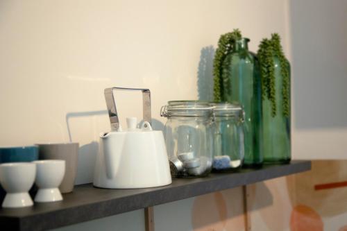 a shelf with glass jars and bottles on it at Silo 161 in Ruinerwold