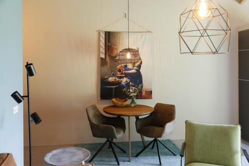 a room with a table and chairs and a painting at Silo 161 in Ruinerwold