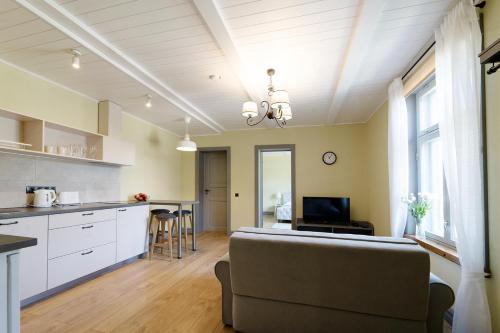 a kitchen and living room with a couch and a table at Verona Apartments - Paide in Paide