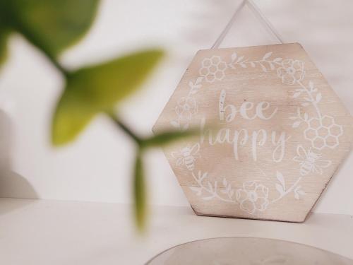 a sign that says be happy sitting on a table at Theatre House Apartment 13 in Coventry