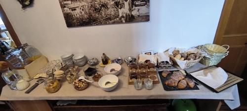 a table with a bunch of donuts and other items at Zimmervermietung Gröberhof in Schenna