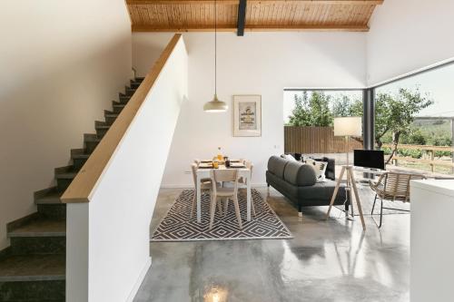 a living room with a staircase and a couch and a table at Villa Arneiro II in Vimeiro