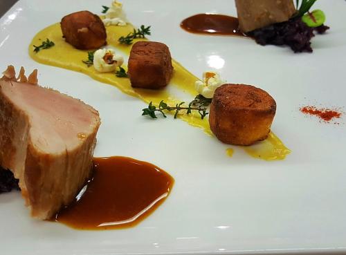 a plate of food with meat and sauce on it at Hôtel Les Grillons in Talloires