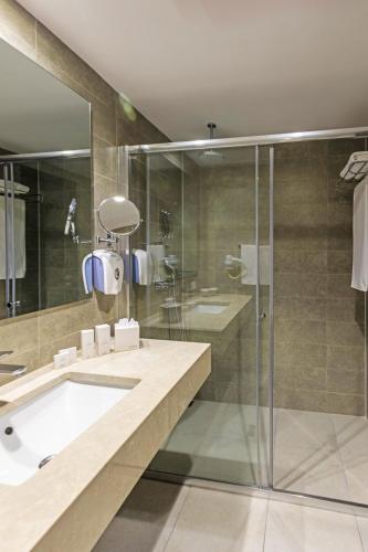 a bathroom with a glass shower and a sink at My Ella Bodrum Resort & Spa in Peksimet