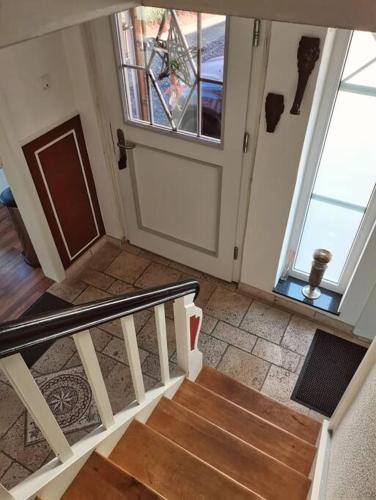 a room with a staircase and a door with a window at Hof Eckens - Ferienhaushaus Marie in Wildeck Bosserode in Wildeck