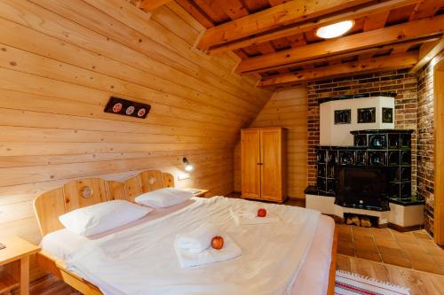 a bedroom with a bed in a wooden cabin at Wellness rezort Jánošíkov dvor in Zázrivá