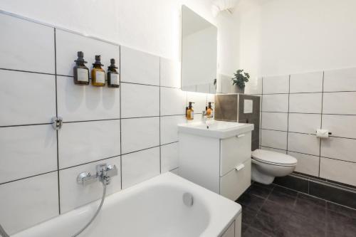 a white bathroom with a sink and a toilet at 80qm Luxuriöse Designerwohnung im Herzen Bochums in Bochum