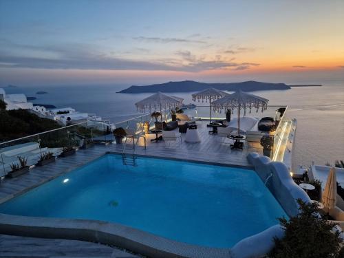 a swimming pool with a view of the ocean at Galaxy Suites & Villas in Imerovigli