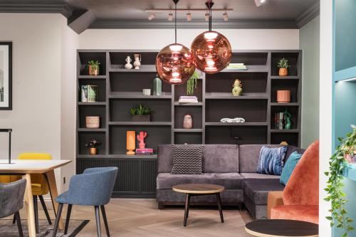 a living room with a couch and a table and chairs at Holiday Inn Leeds-Wakefield M1 Jct40 by IHG in Wakefield