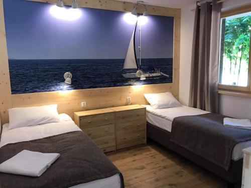 Katil atau katil-katil dalam bilik di Bałtyk Apartamenty Poddąbie