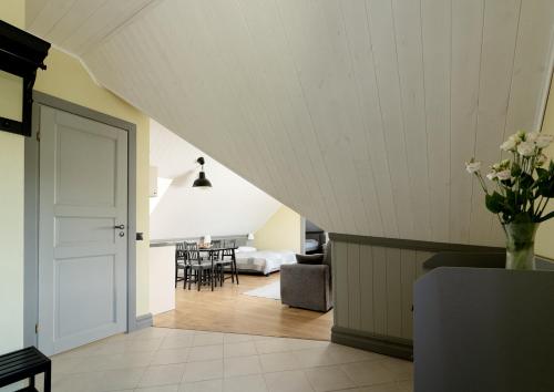 an attic room with a staircase leading to a living room at Verona Apartments - Paide in Paide