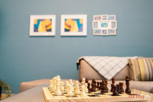 a chess board with chess pieces on a table with paintings at Live like a rockstar in this luxury home in Siġġiewi