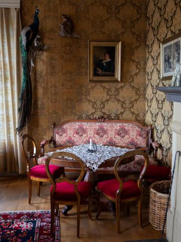 a dining room with a table and a bird on the wall at Sikfors Herrgård in Hällefors