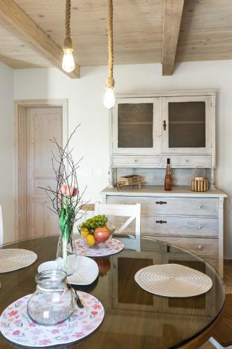 a kitchen with a glass table with a vase of flowers at Stone house Dijana Istria Sveti Lovrec in Sveti Lovreč Pazenatički