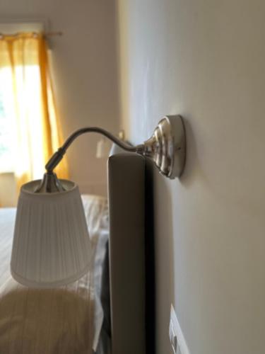 a lamp on a wall next to a bed at Innpiero in Taormina