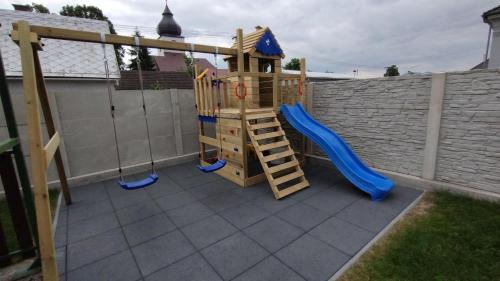 a playground with a slide and a play structure at Apartmány Adam in Liptovská Teplá