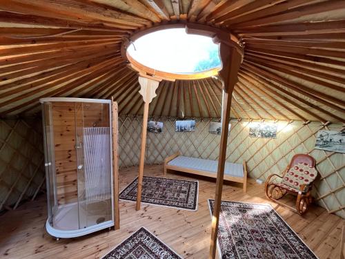 a room with a yurt with rugs on the floor at Mágustanya in Paloznak