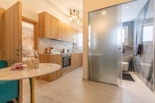 a kitchen with a table and a glass refrigerator at Perfect Living in Rhodes Town