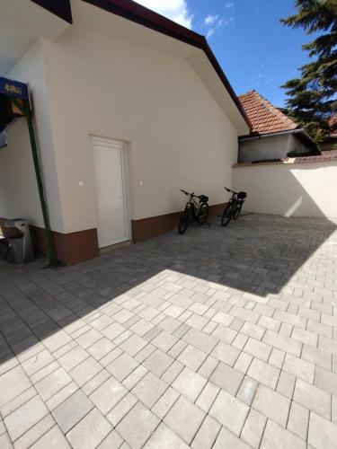 two bikes parked against the side of a building at Apartmány Adam in Liptovská Teplá