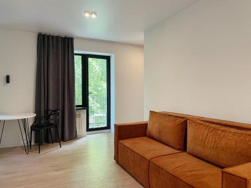 a living room with a couch and a table at Електрика 24 на 7 кондиціонер Bordo city center apartment двокімнатні апартаменти в центрі міста in Poltava