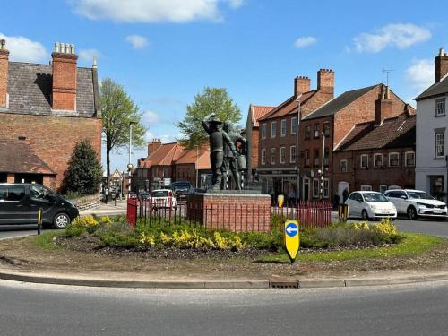 a statue in the middle of a street with buildings at 1 Bed Central Newark Flat 1st Floor in Newark upon Trent