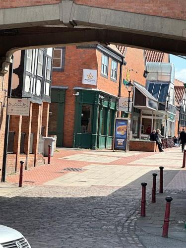 a city street with buildings and a bridge over it at 1 Bed Central Newark Flat 1st Floor in Newark upon Trent
